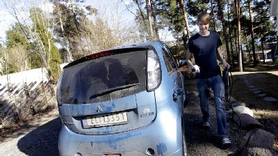 Christian Blakseth, who traded his bicycle for an electric car, charges his vehicle's batteries, in Oslo, 